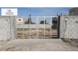 ارض نصف دونم مع سور ارتفاع 2 متر مع رخصة بناء على الاسفلت مباشرة Image 1